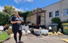 Carla Caldwell at her house in Sandringham with flood damaged belonging shown in the background.