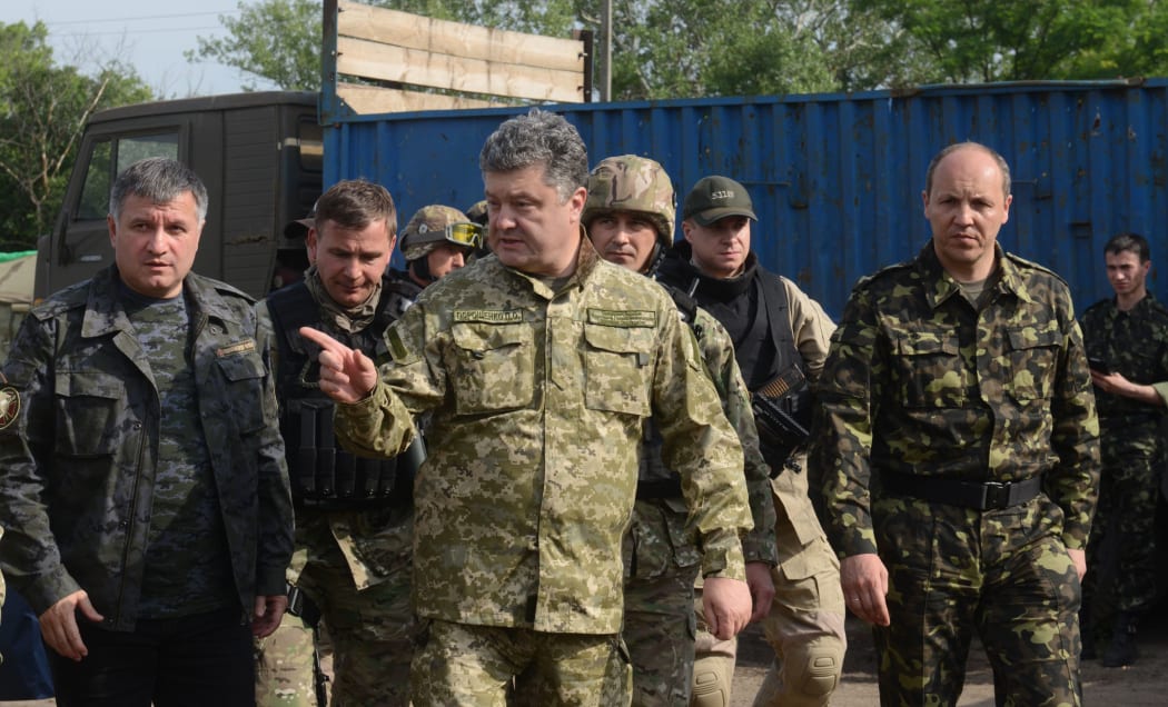 Ukrainian President Petro Poroshenko wearing military fatigues speaks with Ukrainian army's Anti-Terrorist officers.