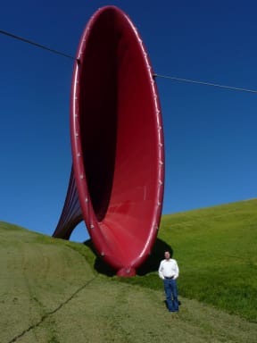 Martin Lodge at The Farm sculpture park, Kaipara Harbour, with Dismemberment 1 by Anish Kapoor, 2011