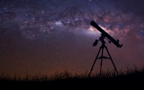 Infinite space background with silhouette of telescope. This image elements furnished by NASA.