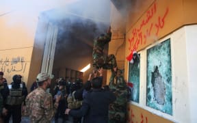 Members of Iraq's Hashed al-Shaabi military network attempt to break into the US embassy in the capital Baghdad, on December 31, 2019.