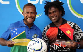 Solomon's Henry Fa'arodo and PNG's David Muta.