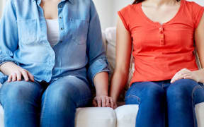 Lesbian couple holding hands.