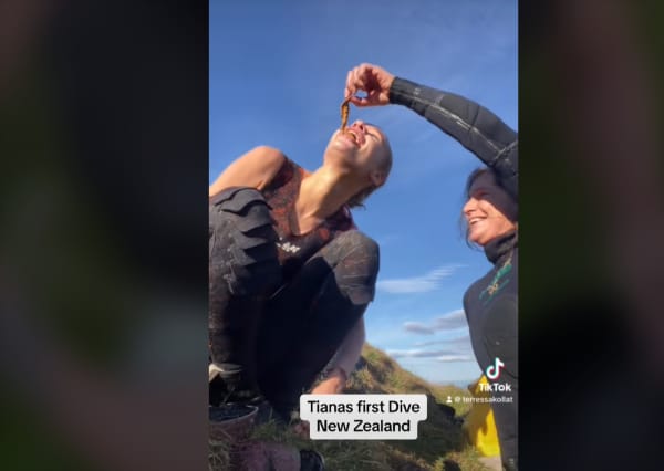 Terressa Kollat gives her niece from Australia a taste of kina after her first diving experience in New Zealand. (Screenshot from TikTok video post in February 2024)