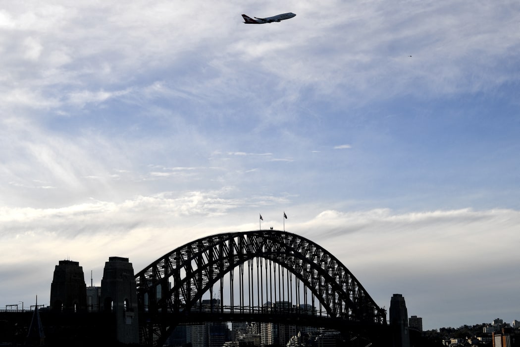 The last Qantas Boeing 747 airliner flies over the Sydney Harbour Bridge during its farewell flight to the US on July 22, 2020.