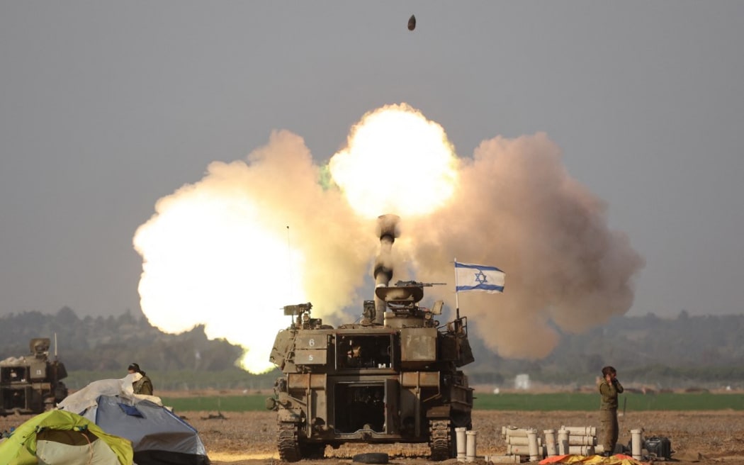 Israeli forces shell the Gaza Strip from the border area in southern Israel on December 12, 2023 amid ongoing battles with the Palestinian Hamas movement. Israel pressed on with its bombing of Gaza on December 12 after saying its campaign to destroy Hamas has left the Palestinian militant group on the "the verge of dissolution". (Photo by JACK GUEZ / AFP)