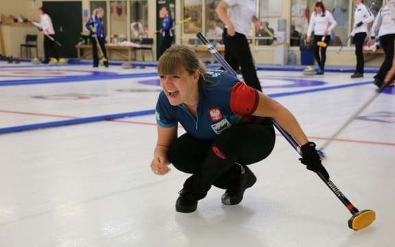 Polish skip Marta Pluta in full cry after releasing a stone