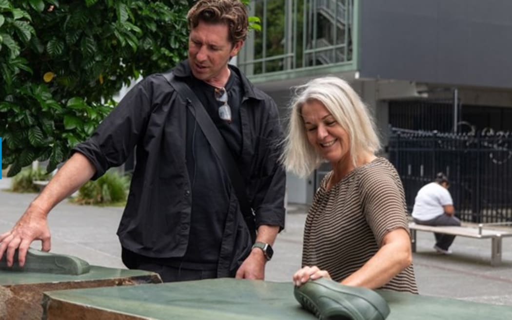 Joe Sheehan and Deb Ward at one of the ancient boulders used for the contemporary art