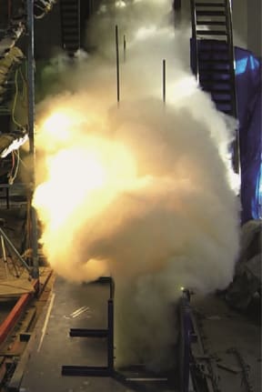 Front view of a pyroclastic flow ash and gas cloud surging down the eruption simulator.