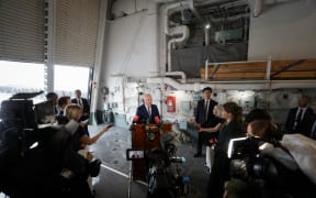 Christopher Luxon holds a media standup in Japan