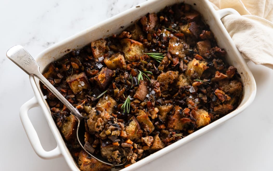 A rectangular baking dish containing Mushroom, rosemary and walnut sourdough stuffing.