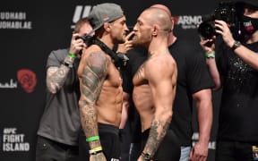 (L-R) Opponents Dustin Poirier and Conor McGregor of Ireland face off during the UFC 257 weigh-in at Etihad Arena on UFC Fight Island on January 22, 2021 in Abu Dhabi, United Arab Emirates.