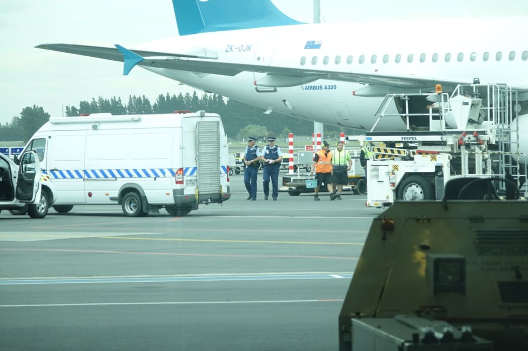 Police and airport staff at Christchurch Airport after white powder was found on an Air New Zealand flight.