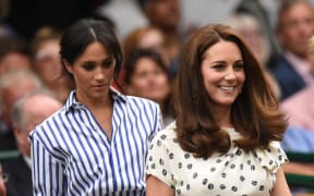 Catherine, Duchess of Cambridge, and Meghan, Duchess of Sussex take their seats at the 2018 Wimbledon Championships