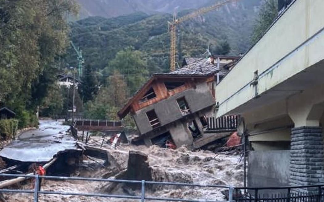 This photo taken on October 3, 2020 and provided by Italian news agency ANSA shows a three-storey building under renovation that collapsed next to a watercourse following bad weather and floods in Limone Piemonte, near Cuneo, Piedmont.