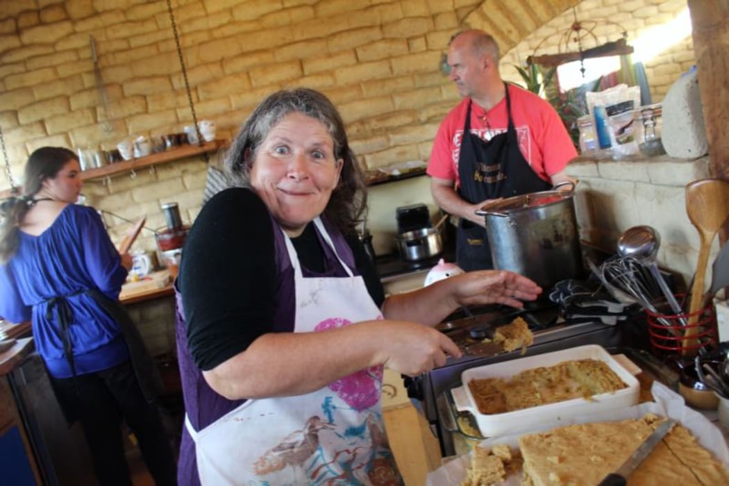 This is an image of Daring Donna the cook in the kitchen. Donna's partner, furniture maker  Darren Hunter is in the background , and youth crew member Jade.