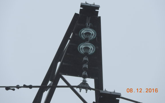 Three transmission towers have a number of their glass insulators damaged.