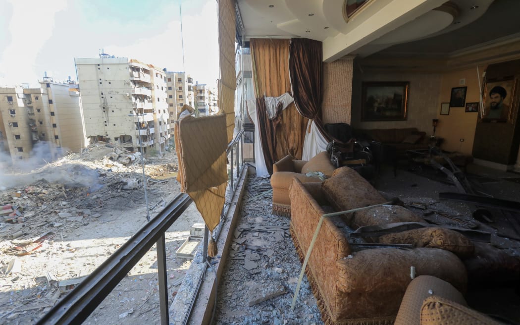 A portrait of Hezbollah leader Hassan Nasrallah hangs on the wall of a heavily damaged apartment in the Hadath neighbourhood of Beirut's southern suburbs on September 28, 2024 in the aftermath of overnight Israeli airstrikes on the outskirts of the Lebanese capital. Israeli fighter jets bombarded the southern suburbs of Beirut overnight into September 28, sending panicked families fleeing massive strikes that were reportedly targeting Nasrallah. (Photo by AFP)