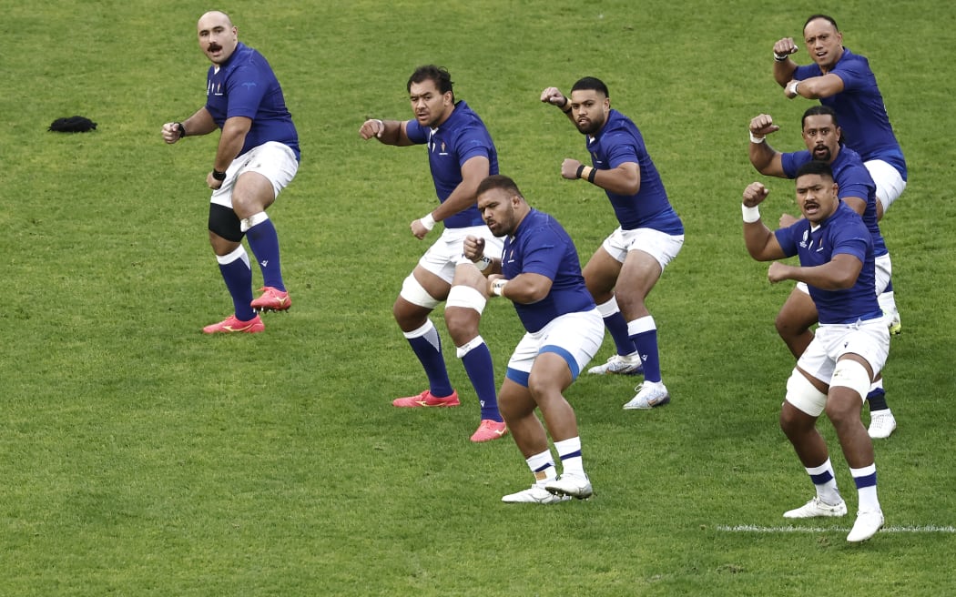 Samoa's players perform the Siva Tau war dance ahead of the France 2023 Rugby World Cup Pool D match between England and Samoa at the Stade Pierre-Mauroy in Villeneuve-d'Ascq, near Lille, northern France on October 7, 2023. (Photo by Sameer Al-Doumy / AFP)