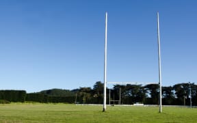Goal posts for football, rugby union or league on field. Concept photo of sport, achievement mission and goals.