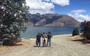 Tyler Nii’s parents and brother looking out over Lake Wakatipu.