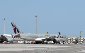 A Qatar Airways Airbus A350-941 aircraft is seen on the tarmac at Hamad International Airport in the Qatari capital Doha.