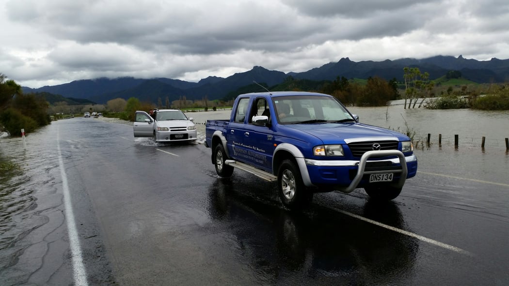 A car is towed after becoming caught in floodwaters on the way to Pauanui in the Coromandel.