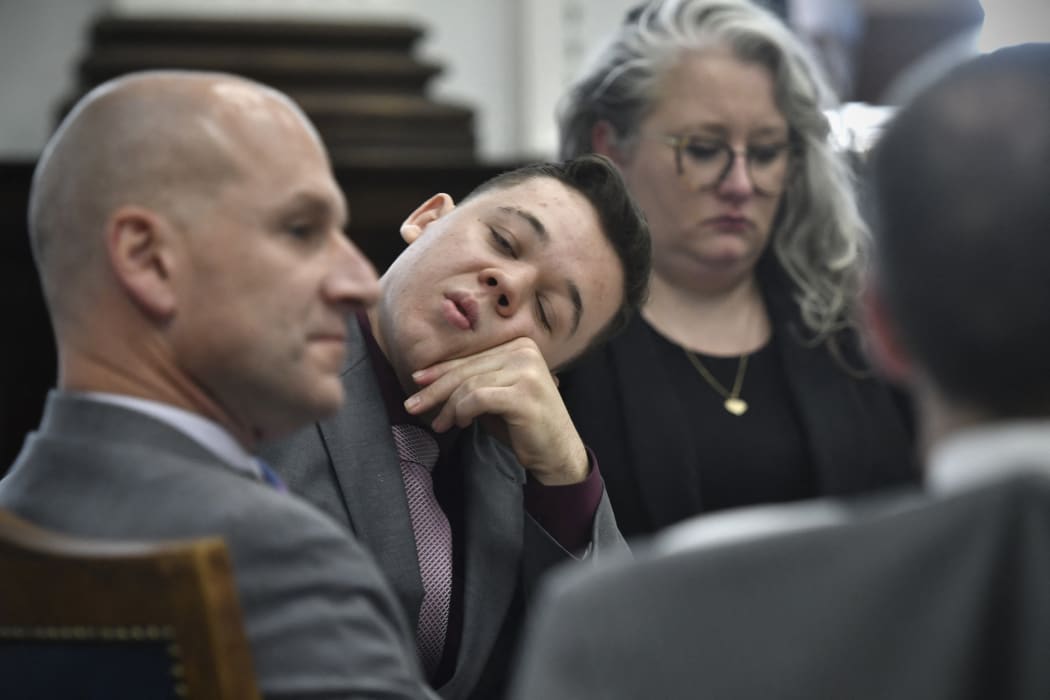 Kyle Rittenhouse sits with his attorneys after a lunch break and waits for proceedings to start at the Kenosha County Courthouse on November 9, 2021 in Kenosha, Wisconsin.
