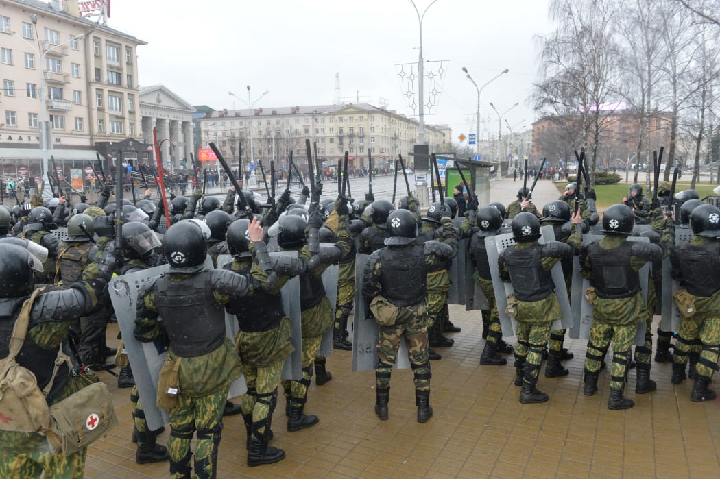 Riot police stand ready during an unauthorized protest in Minsk over the tax on those employed less than 183 days a year, labelled "social parasites".
