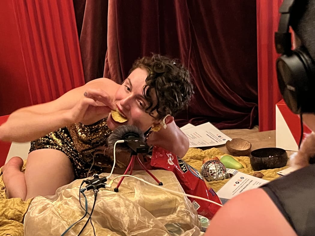 Letitia Lickkit crunches corn chips at the ASMR Bar at Splore