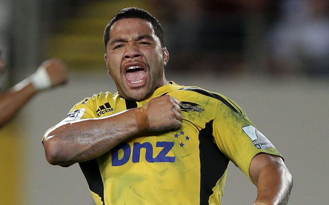 Hurricanes hooker Motu Matu'u celebrates scoring a try.