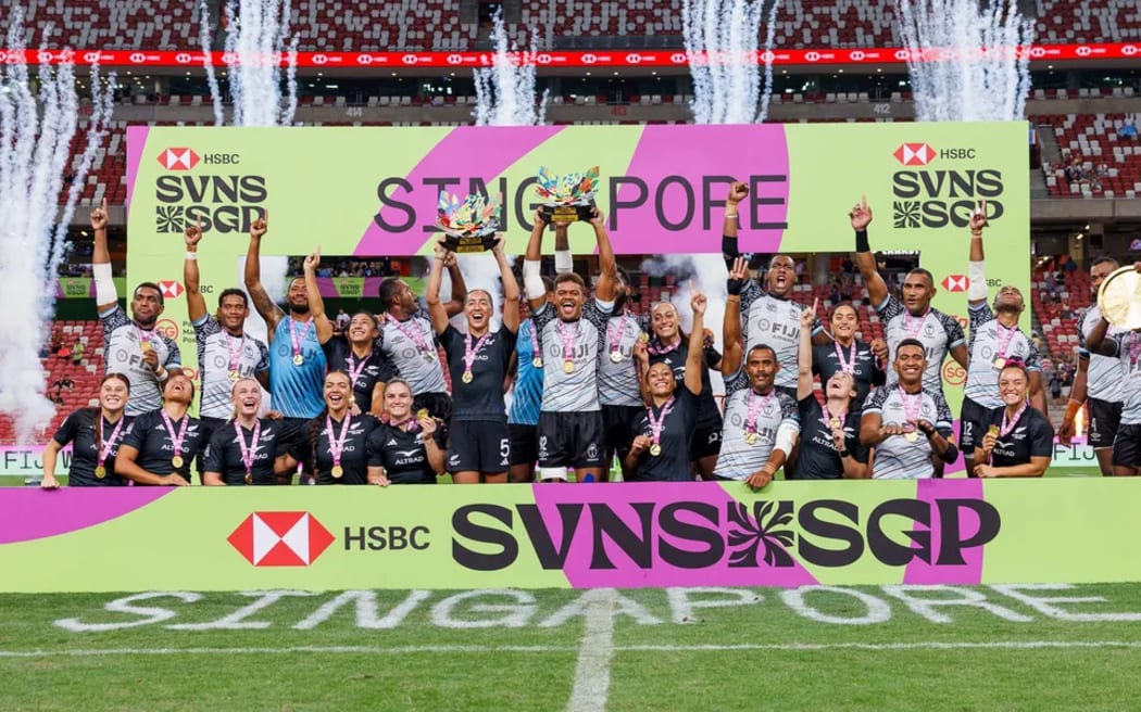New Zealand women and Fiji men celebrate their Cup victory at the 2025 HSBC SVNS Singapore at Singapore National Stadium on April 6, 2025 in Singapore. (Photo by Zach Franzen / World Rugby)