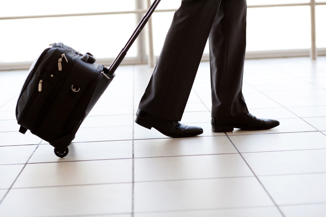 12884130 - silhouette of businessman walking in airport