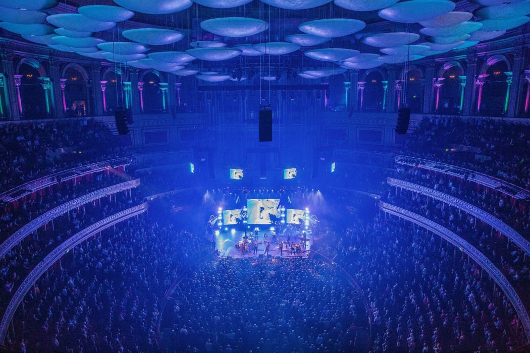 A packed Royal Albert Hall in London where the BBC Symphony Orchestra conducted by Jules Buckley perform a brand new comission for the BBC Proms 2022 written by the band Public Service Broadcasting to celebrate the Centenary of BBC Radio.