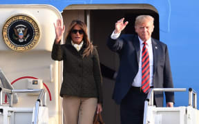 US President Donald Trump waves as he disembarks Air Force One with US First Lady Melania Trump at Prestwick Airport, south of Glasgow on 13 July, 2018.