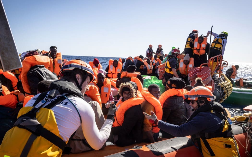 This photo taken on March 13, 2024 and handout on March 14, 2024 by international humanitarian organization SOS Mediterranee, shows a rescuing operation of migrants by the Ocean Viking rescue vessel in the Libyan search and rescue region in international waters. The Ocean Viking migrant rescue vessel chartered by SOS Mediterranee rescued 25 people off the coast of Libya on March 13, 2024, who had been in "an inflatable boat adrift" for "around a week", the NGO said in a press release. "Those rescued report that many people have died and are now missing", said SOS Mediterranee. (Photo by Johanna de TESSIERES / SOS MEDITERRANEE / AFP) / RESTRICTED TO EDITORIAL USE - MANDATORY CREDIT "AFP PHOTO / HO / JOHANNA de TESSIERES / SOS MEDITERRANEE   " - NO MARKETING NO ADVERTISING CAMPAIGNS - DISTRIBUTED AS A SERVICE TO CLIENTS