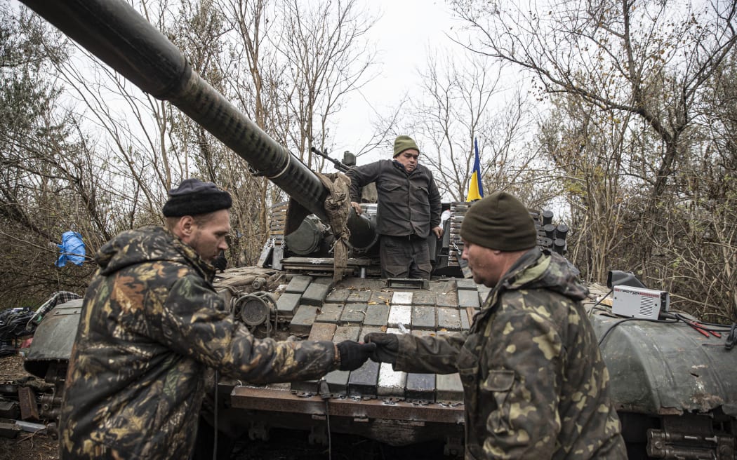 Ukrainian soldiers work to repair a damaged tank as Ukrainian Armed Forces' military mobility continue toward Kherson front in Ukraine on November 9, 2022. Ukrainian army continue to support its units in Kherson as Russia-Ukraine war continues. Metin Aktas / Anadolu Agency (Photo by Metin Aktas / ANADOLU AGENCY / Anadolu Agency via AFP)