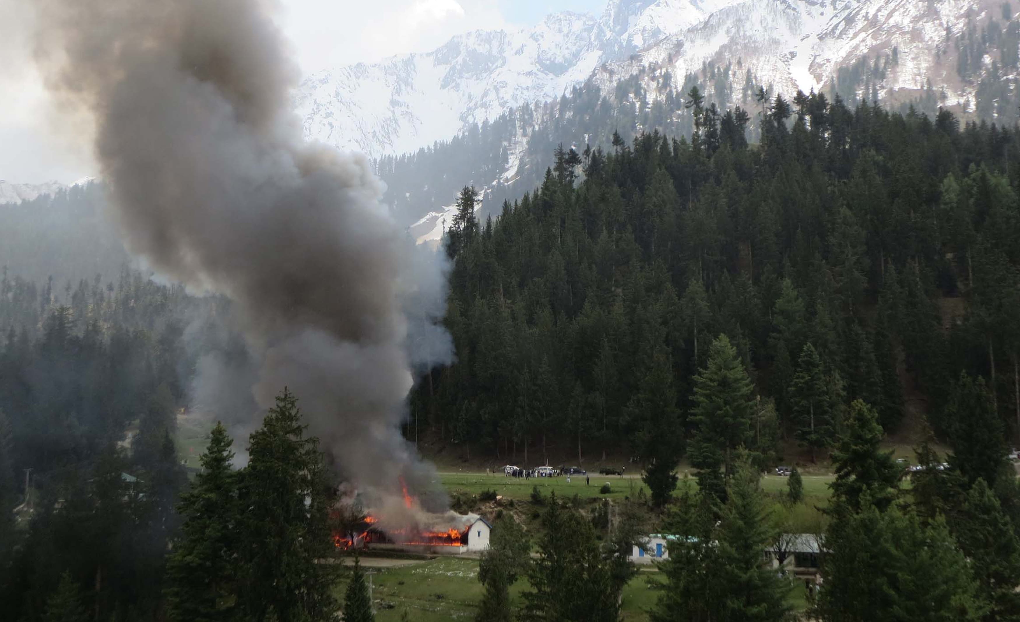 Flame and smoke rises from the site where a Pakistani military helicopter crashed in the northern area of Gilgit on 8 May 2015.