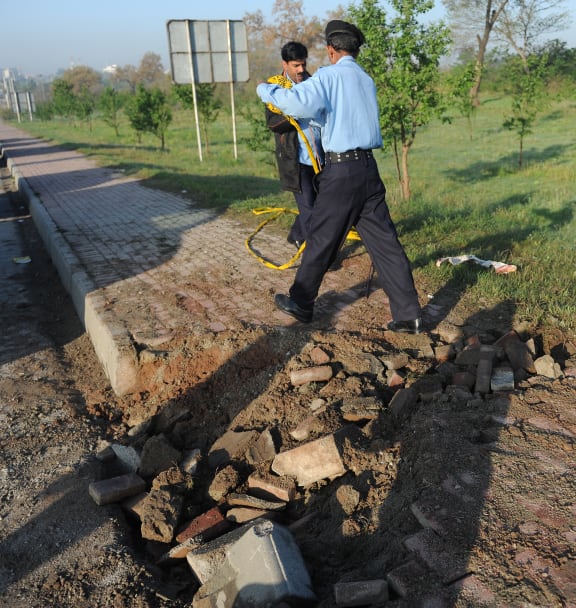 Police inspect the site of the explosion in Islamabad.