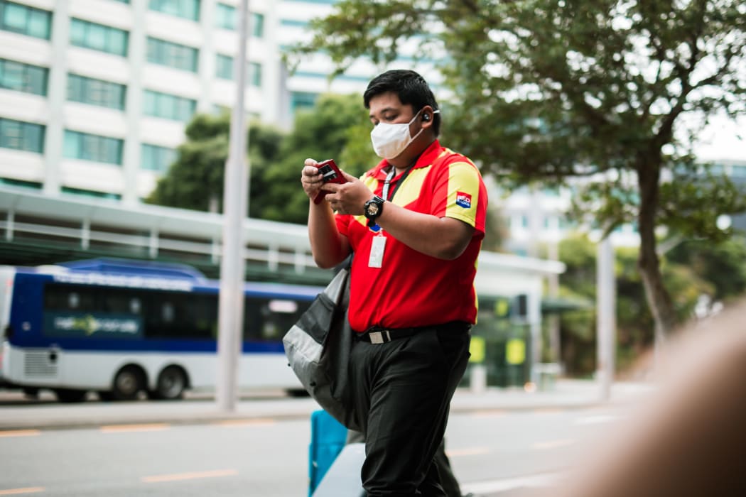 A man wears a mask during level 2 in Wellington, 15 February 20201.