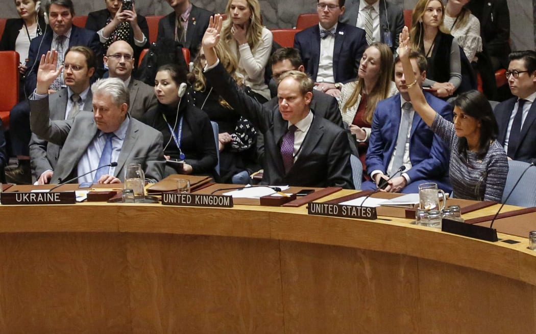 Members of the UN Security Council vote 15-0 to impose new sanctions on North Korea during a Security Council meeting over North Korea on December 22, 2017, at UN Headquarters in New York City.   / AFP PHOTO / KENA BETANCUR