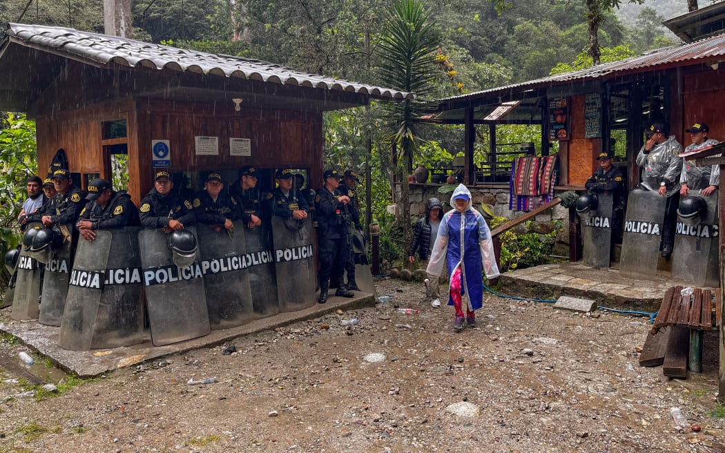 Riot police guard the entrance to the trail leading to the ruins from Machu Picchu Pueblo, Peru, on January 28, 2024.