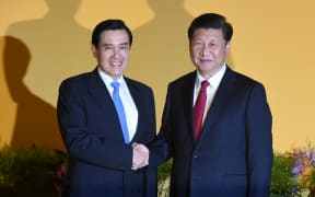 Chinese President Xi Jinping (right shakes hands with Taiwan President Ma Ying-jeou before their meeting