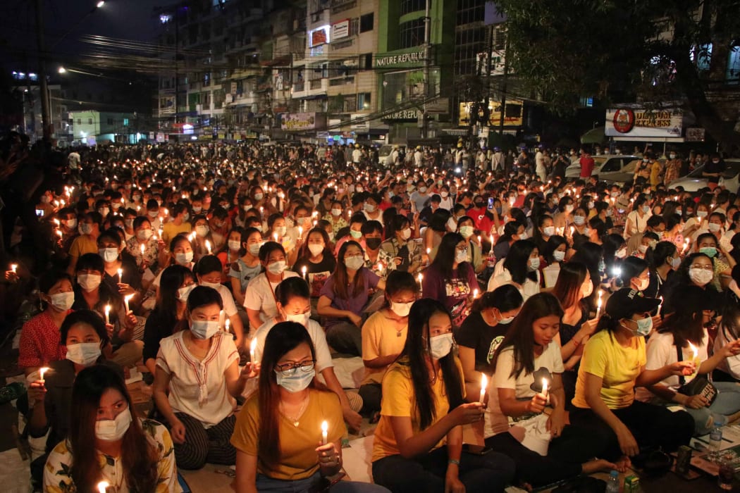 Protesters in Yangon hold candles on Saturday, in a display against a military coup and detention of elected government in Myanmar.