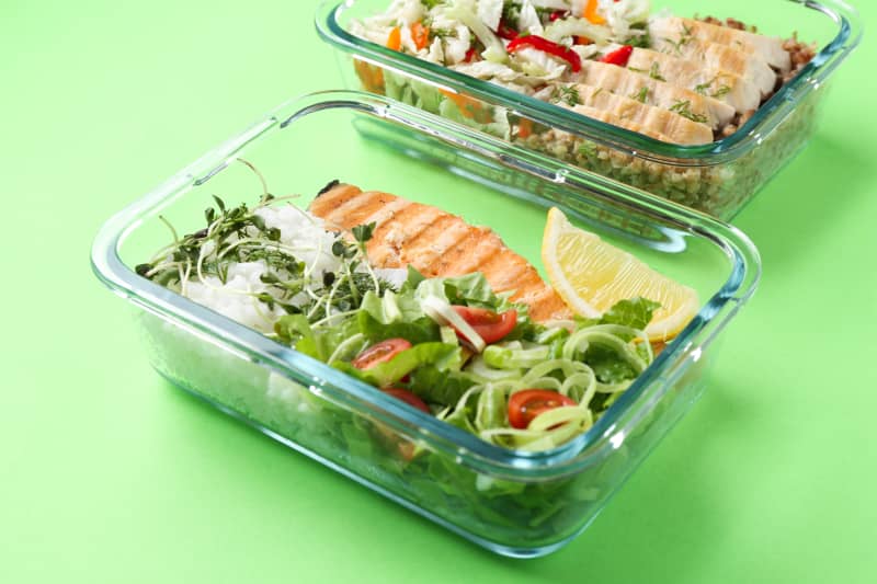 Healthy meal. Different products in glass containers on green background