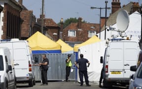 Police officers stand guard at a cordon near Rollestone Street, in Salisbury, in 2018 after the exposure of a British couple to the same nerve agent used against former Russian double agent Sergei Skripal. caption