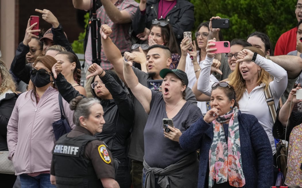 FAIRFAX, VA - MAY 27: Onlookers jeer and gesture as actress Amber Heard departs the Fairfax County Courthouse on May 27, 2022 in Fairfax, Virginia.