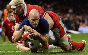 France's Maxime Lucu dives over the line to score against Wales, Six Nations, 2024.
