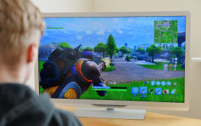 A boy plays Fortnite.