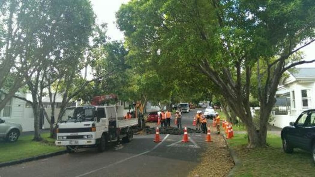 Watercare staff inspecting the sinkhole in Islington Street.